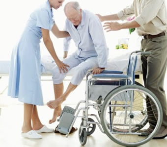 Person being helped into a wheelchair