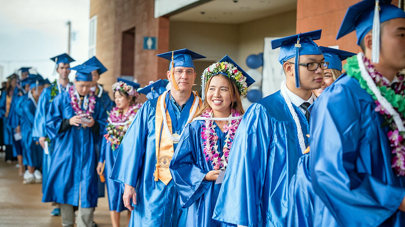 students in gowns for graduation procession