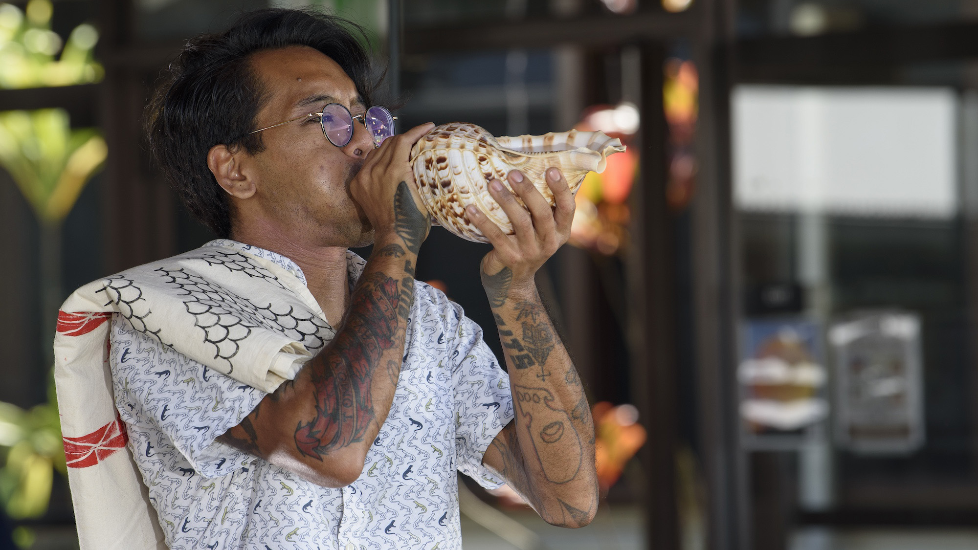 student blowing a conch